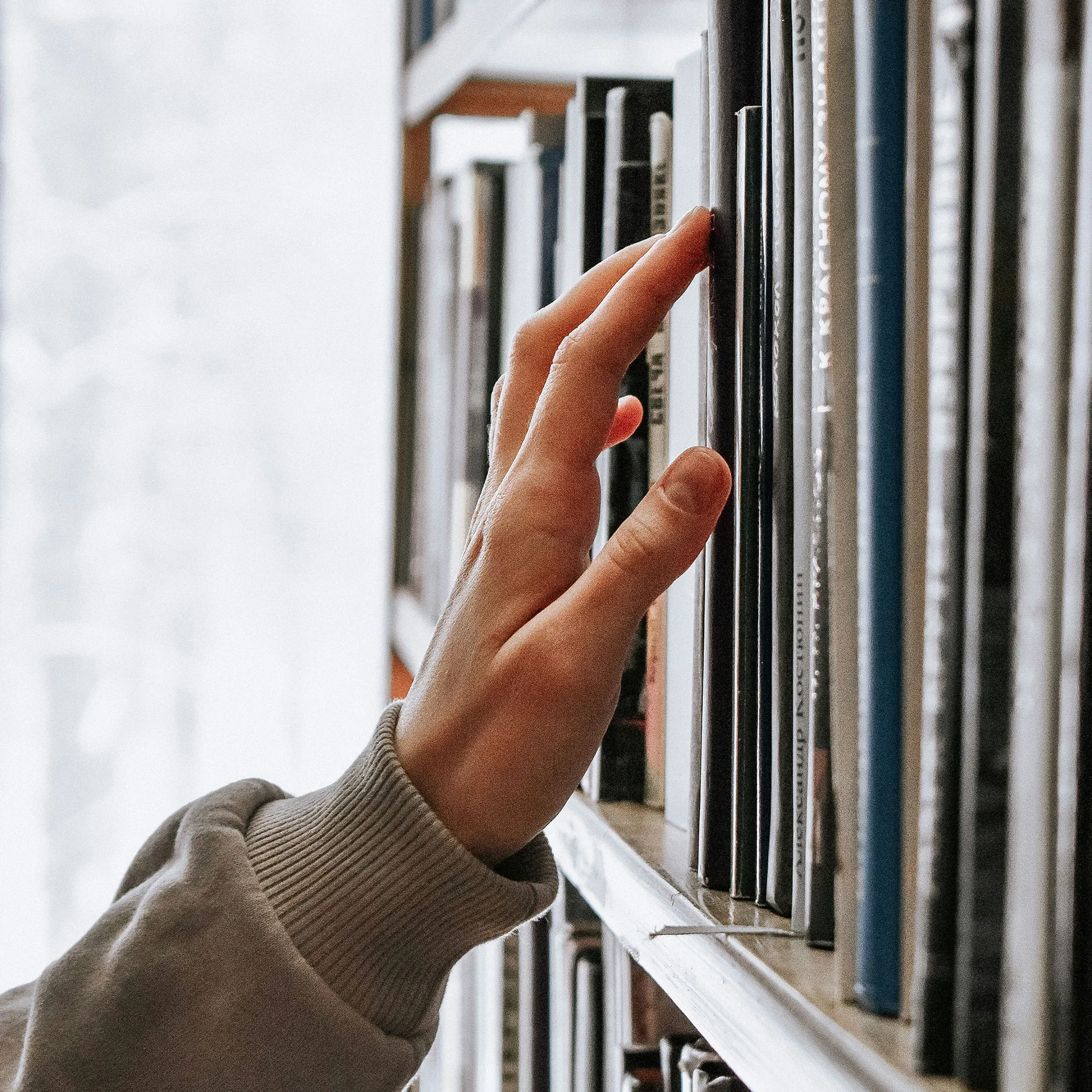 Hand som letar böcker